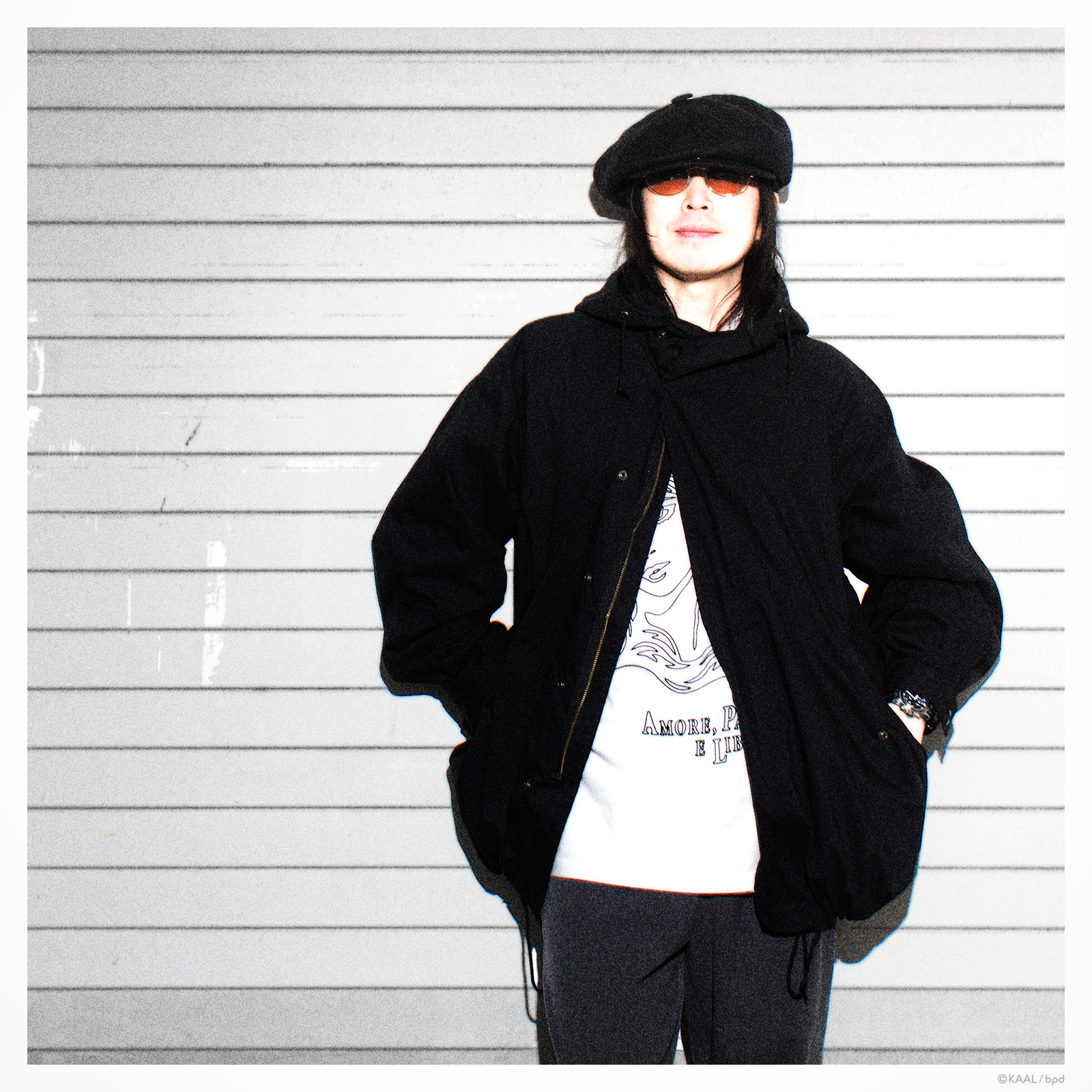 A portrait of artist KAAL wearing a T-shirt he designed himself